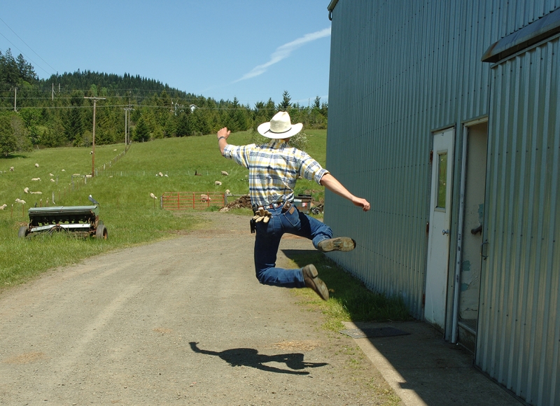 Student jumping at the sheep barn